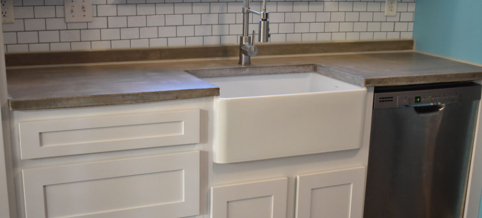 How does a farmhouse sink sit on a cabinet?